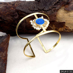 Elegant Gold Cuff Bracelet with Blue Stone and Pearl Accents